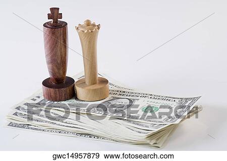 Chess pieces on stack of US paper currency View Large Photo Image Stock Photo - Chess pieces on stack of US paper currency. Fotosearch