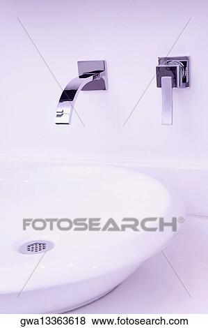 Stock Photo - Close-up of a bathroom sink and a faucet. Fotosearch