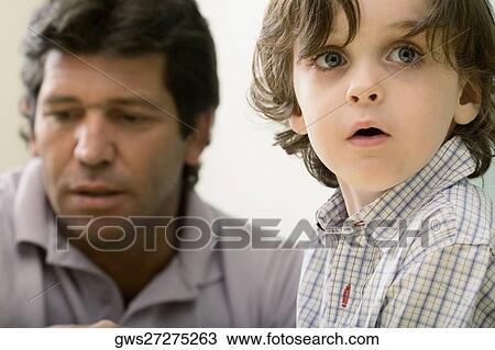 Close-up of a boy with his male teacher in the background View Large Photo Image Stock Image - Close-up of a boy with his male teacher in the background. Fotosearch