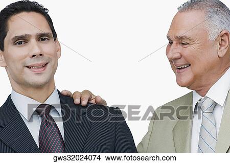 Close-up of a businessman putting his hand on another businessman's shoulders View Large Photo Image Picture - Close-up of a businessman putting his hand on another businessman's shoulders. Fotosearch