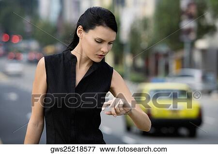 Close-up of a businesswoman checking the time View Large Photo Image Stock Photo - Close-up of a businesswoman checking the time. Fotosearch