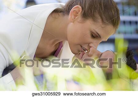Stock Photo - Close-up of a businesswoman romancing with a businessman. Fotosearch
