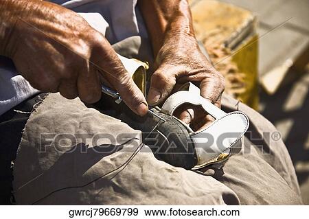Close-up of a cobbler repairing a shoe, HohHot, Inner Mongolia, China View Large Photo Image Stock Photo - Close-up of a cobbler repairing a shoe, HohHot, Inner Mongolia, China. Fotosearch
