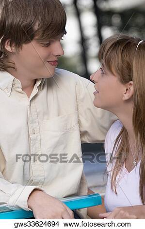 Picture - Close-up of a couple smiling at each other. Fotosearch