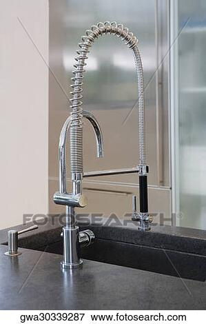 Close-up of a faucet on a kitchen counter View Large Photo Image Stock Photo - Close-up of a faucet on a kitchen counter. Fotosearch