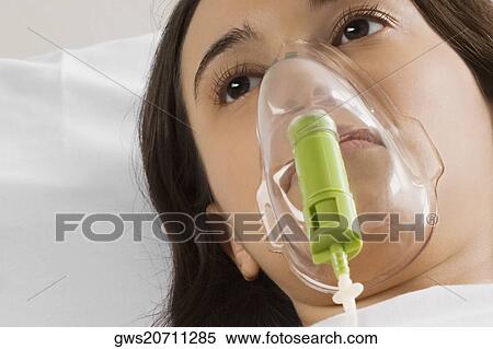 Close-up of a female patient wearing an oxygen mask View Large Photo Image Stock Photography - Close-up of a female patient wearing an oxygen mask. Fotosearch