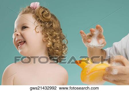 Close-up of a girl playing with her father View Large Photo Image Stock Image - Close-up of a girl playing with her father. Fotosearch