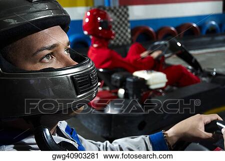 Close-up of a male go-cart racer in a sports car View Large Photo Image Stock Image - Close-up of a male go-cart racer in a sports car. Fotosearch