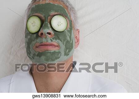 Close-up of a mature man lying on a massage table with facial mask on his face View Large Photo Image Stock Image - Close-up of a mature man lying on a massage table with facial mask on his face. Fotosearch