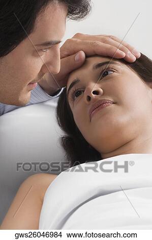Picture - Close-up of a mid adult man consoling a female patient. Fotosearch