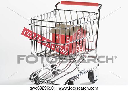 Stock Image - Close-up of a model home in a shopping cart. Fotosearch