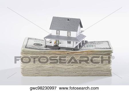 Stock Photo - Close-up of a model home on the top of US dollar bills. Fotosearch