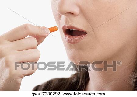 Close-up of a patient taking a capsule View Large Photo Image Stock Image - Close-up of a patient taking a capsule. Fotosearch