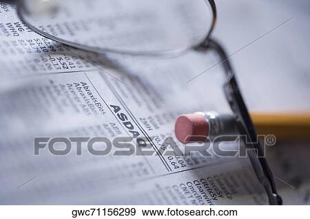 Close-up of a pencil with eyeglasses on a financial newspaper View Large Photo Image Stock Photo - Close-up of a pencil with eyeglasses on a financial newspaper. Fotosearch