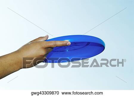 Close-up of a person's hand holding a plastic disc View Large Photo Image Stock Image - Close-up of a person's hand holding a plastic disc. Fotosearch