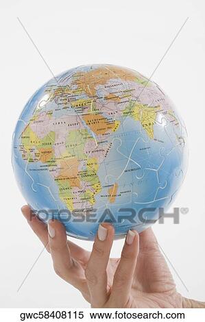 Close-up of a person's hand holding a globe View Large Photo Image Stock Photography - Close-up of a person's hand holding a globe. Fotosearch