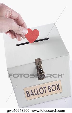 Close-up of a person's hand inserting a heart shaped vote into a ballot box View Large Photo Image Stock Image - Close-up of a person's hand inserting a heart shaped vote into a ballot box. Fotosearch