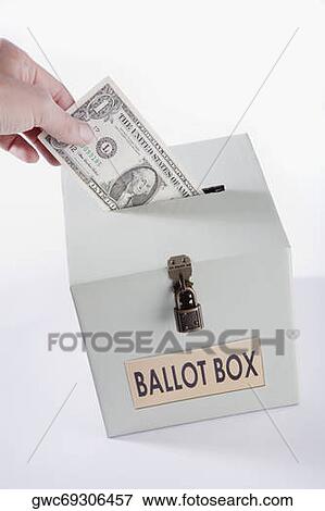 Close-up of a person's hand inserting a US dollar bill into a ballot box View Large Photo Image Stock Photo - Close-up of a person's hand inserting a US dollar bill into a ballot box. Fotosearch