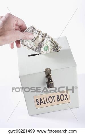 Close-up of a person's hand inserting a US dollar bill into a ballot box View Large Photo Image Stock Photo - Close-up of a person's hand inserting a US dollar bill into a ballot box. Fotosearch