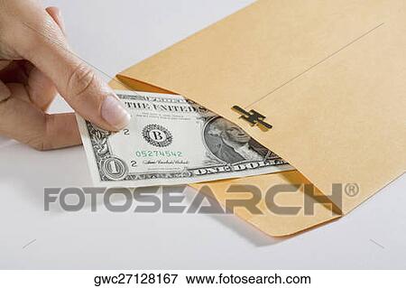 Close-up of a person's hand picking out a US dollar bill from an envelope View Large Photo Image Stock Photo - Close-up of a person's hand picking out a US dollar bill from an envelope. Fotosearch