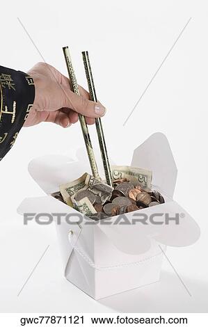 Close-up of a person's hand picking coins with chopsticks View Large Photo Image Stock Image - Close-up of a person's hand picking coins with chopsticks. Fotosearch