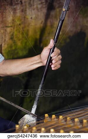 Close-up of a person's hand playing erhu, Fuli Village, Yangshuo, Guangxi Province, China View Large Photo Image Stock Photograph - Close-up of a person's hand playing erhu, Fuli Village, Yangshuo, Guangxi Province, China. Fotosearch