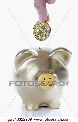 Close-up of a person's hand putting a coin into a piggy bank View Large Photo Image Stock Photo - Close-up of a person's hand putting a coin into a piggy bank. Fotosearch