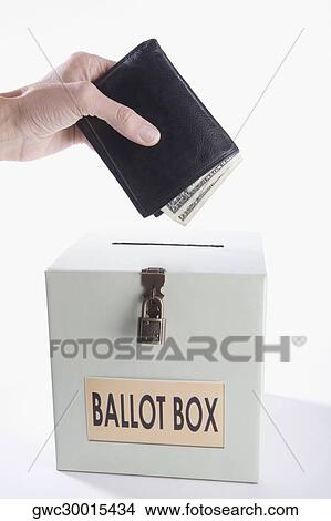 Close-up of a person's hand putting money full of wallet into a ballot box View Large Photo Image Picture - Close-up of a person's hand putting money full of wallet into a ballot box. Fotosearch