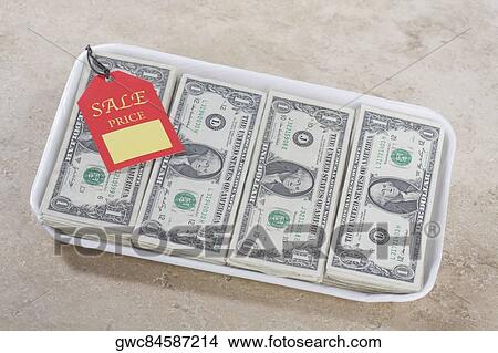 Close-up of a price tag on a container filled with US dollar bills View Large Photo Image Picture - Close-up of a price tag on a container filled with US dollar bills. Fotosearch