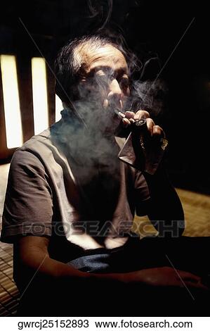 Close-up of a senior man smoking a cigar, Jinkeng Terraced Field, Guangxi Province, China View Large Photo Image Stock Image - Close-up of a senior man smoking a cigar, Jinkeng Terraced Field, Guangxi Province, China. Fotosearch