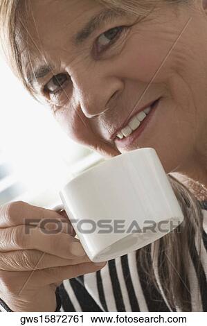 Stock Image - Close-up of a senior woman having coffee. Fotosearch