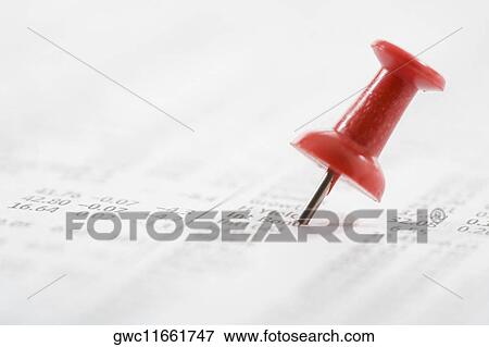 Close-up of a straight pin on a financial newspaper View Large Photo Image Stock Photo - Close-up of a straight pin on a financial newspaper. Fotosearch