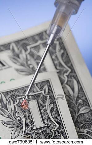 Close-up of a syringe on a US dollar bill View Large Photo Image Stock Image - Close-up of a syringe on a US dollar bill. Fotosearch