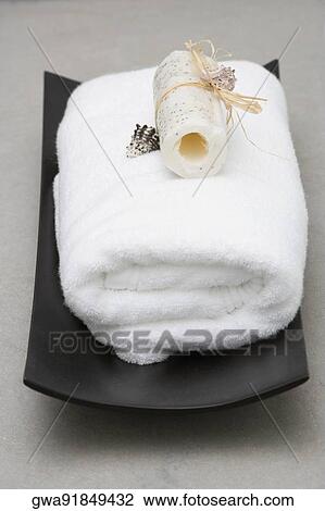 Stock Image - Close-up of a towel with a loofah. Fotosearch