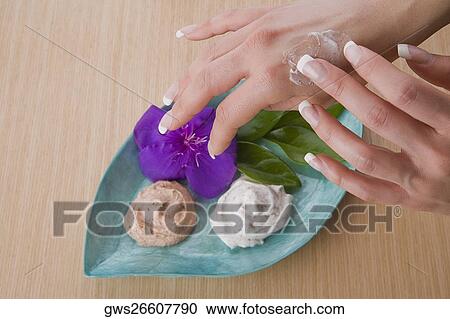 Close-up of a woman's hand applying cream View Large Photo Image Stock Image - Close-up of a woman's hand applying cream. Fotosearch