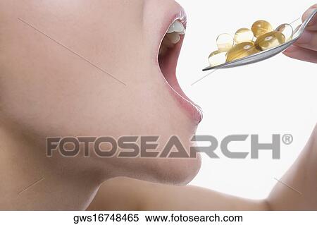 Close-up of a young woman taking a spoon full of pills View Large Photo Image Stock Photography - Close-up of a young woman taking a spoon full of pills. Fotosearch
