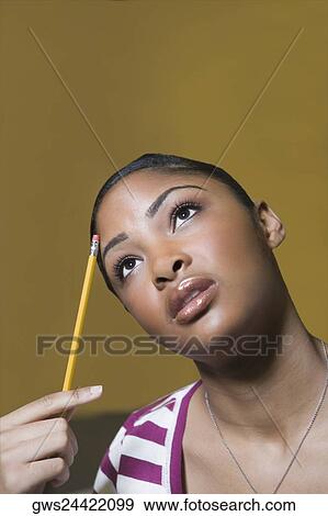 Stock Photo - Close-up of a young woman thinking. Fotosearch