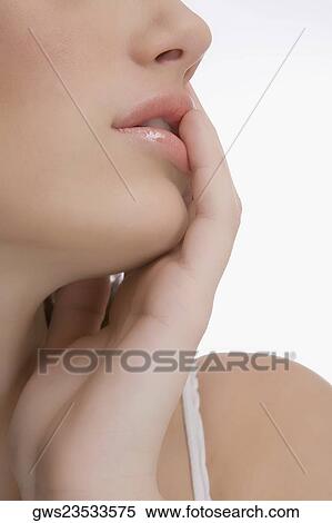 Stock Photography - Close-up of a young woman touching her lips. Fotosearch