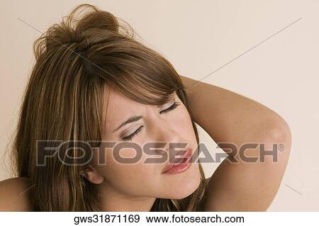 Stock Photo - Close-up of a young woman with her eyes closed. Fotosearch