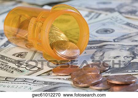 Close-up of coins and pill bottle on US paper currency View Large Photo Image Stock Image - Close-up of coins and pill bottle on US paper currency. Fotosearch