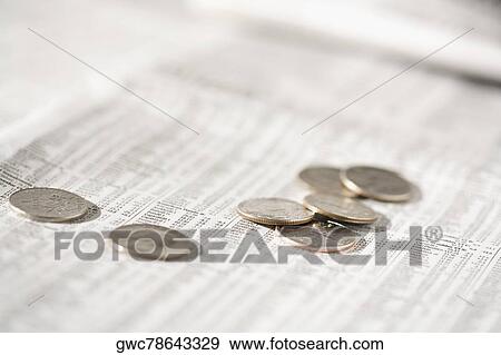 Close-up of coins on a financial newspaper View Large Photo Image Stock Photo - Close-up of coins on a financial newspaper. Fotosearch