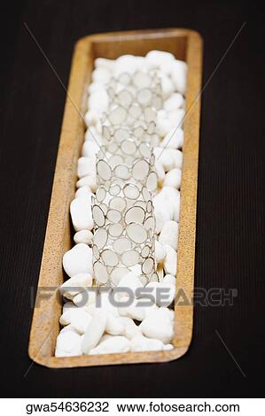 Stock Image - Close-up of decorative glasses on pebbles. Fotosearch
