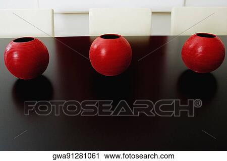 Close-up of decorative urns on a dining table in a dining room View Large Photo Image Stock Image - Close-up of decorative urns on a dining table in a dining room. Fotosearch