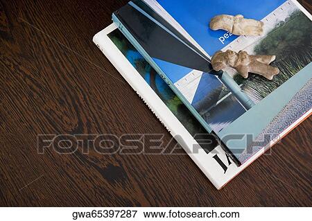 Stock Photo - Close-up of figurines on magazines on a table. Fotosearch