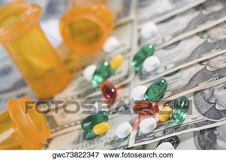Stock Photo - Close-up of medicines and pill bottles on US paper currency. Fotosearch