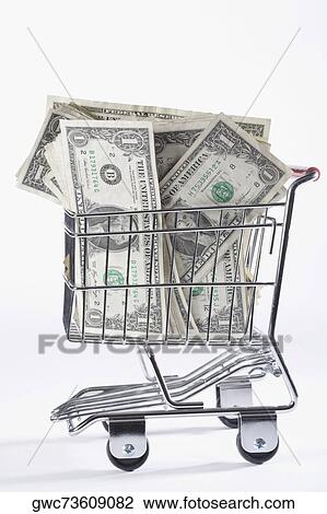 Stock Image - Close-up of paper currency in a shopping cart. Fotosearch