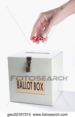 Close-up of person's hand holding two dices over a ballot box View Large Photo Image Picture - Close-up of person's hand holding two dices over a ballot box. Fotosearch