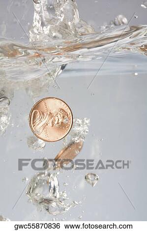 Close-up of two coins in water View Large Photo Image Stock Photograph - Close-up of two coins in water. Fotosearch