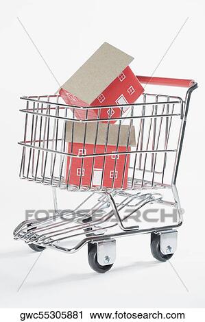 Stock Image - Close-up of two model homes in a shopping cart. Fotosearch
