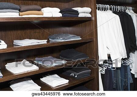 Stock Photograph - Clothes in a clothes rack. Fotosearch